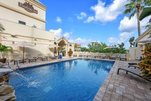 a swimming pool in front of a building at Bayfront Inn 5th Avenue in Naples