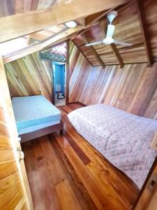 a bedroom with a bed and a ceiling at Casa Numú in Cahuita