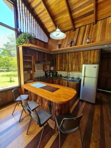 a kitchen with a large wooden table and chairs at Casa Numú in Cahuita