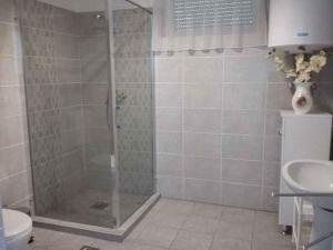 a shower with a glass door in a bathroom at Holiday home in Balatongyörök 42694 in Balatongyörök