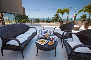 a table with a tray of food on a patio at Best Western Premier Majestic Ponta Negra Beach in Natal