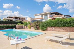 a swimming pool in front of a house at Holiday home in Monte Petrosu 42787 in Monte Petrosu