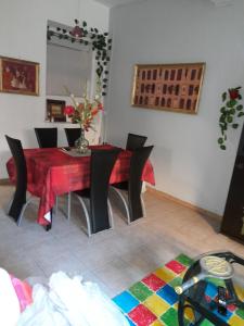 a dining room with a red table and chairs at Maison LUCIA in Saint-Pierre