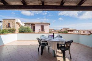 a table and chairs sitting on a patio at Holiday home in Monte Petrosu 42788 in Monte Petrosu