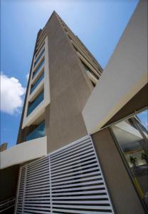 a tall building with windows on the side of it at Premium Flat Praia Calma in Natal