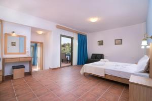 a hotel room with a bed and a mirror at Petra Natura in Limenaria