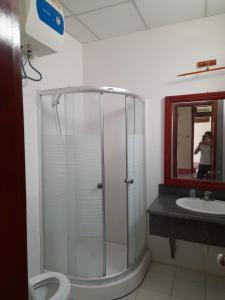 a bathroom with a shower with a toilet and a sink at Khách sạn Vườn Quốc gia Ba Bể in Bak Kan