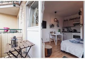Una habitación con una cama y una cocina con una mesa. en Die kleine „Louise“ in der Neustadt mit Tiefgarage, en Dresden