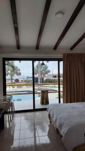 a bedroom with a bed and a view of a pool at Howard Johnson by Wyndham Montañita in Montañita