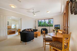 a living room with a table and a couch at Myconos Resort in Maroochydore
