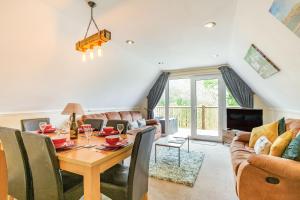 a living room with a table and a couch at Dart Lodge in Callington