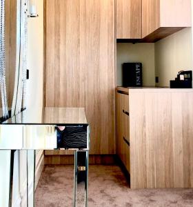a kitchen with a counter and a desk with a microwave at Beach Escape Studio Walk To The Beach in Rosebud