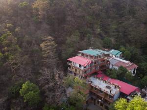 an aerial view of a house with red roof at Hill Top Swiss Cottage in Rishīkesh