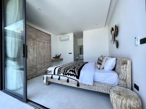 a bedroom with a bed and a glass door at AURA AIR 1, pool & seaview villa, Choengmon 500m in Koh Samui  +20 photos