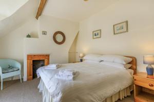a bedroom with a large bed with towels on it at Sea Spray in Watchet