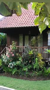 a house with a bunch of flowers in front of it at The Niti Hut's Lembongan in Nusa Lembongan
