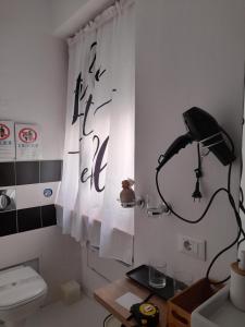 a bathroom with a toilet and a desk with a lamp at Portico 32 - Merano centro in Merano