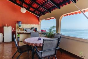 a kitchen and dining room with a table and chairs at Casa Vista Magica in Yelapa