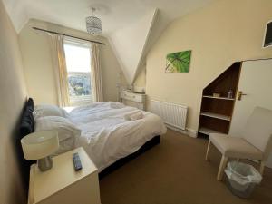 a bedroom with a large bed and a window at South Dene Hotel in Bridlington