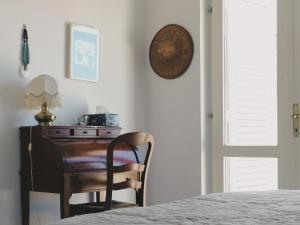a bedroom with a desk and a chair next to a bed at Villa Marina in Brela
