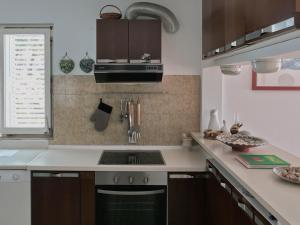 a kitchen with a sink and a stove at Villa Marina in Brela