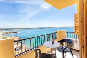 a balcony with a table and chairs and the ocean at Apartamentos Piza in Colonia Sant Jordi