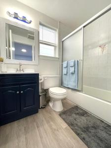 a bathroom with a sink and a toilet and a tub at Golden Gate Park Suite in San Francisco