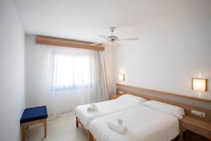 a bedroom with two beds and a window at Apartamentos Lemar in Colonia Sant Jordi