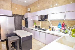 a kitchen with white cabinets and a counter top at Executive 4 bedroom house in Lagos