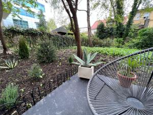 a metal bench sitting in a garden with plants at Center City Apartment in Zagreb
