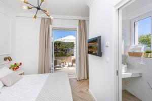 a bedroom with a bed and a sliding door to a patio at Rooms D&L, FREE Parking on-site in Dubrovnik
