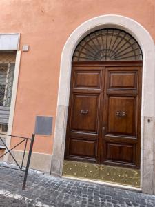 une grande porte en bois sur un bâtiment dans l'établissement New Apartment Sistina 2, à Rome