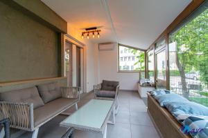 a living room with a couch and a table at MODERN apartments WAVE near the AIRPORT in Velika Gorica
