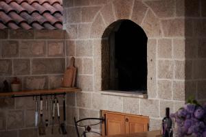 a kitchen with a stone wall with a window at Apartments Micika in Cavtat