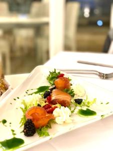 a white plate of food on a table at Ganimede Hotel in Sperlonga