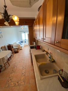 a kitchen with a sink and a living room at Loutra Hills in Loutra +57 photos