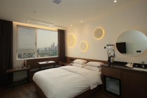 a hotel room with a bed and a mirror at Hotel The Designers Hongdae in Seoul