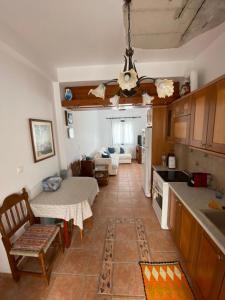a kitchen and living room with a table and a couch at Loutra Hills in Loutra