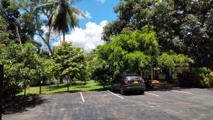 a car parked in a parking lot with trees at The Countryside Udawalawe in Udawalawe