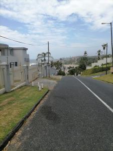 an empty street next to a house with a fence at OCEAN GARDENS 5 in Margate