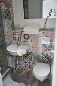a bathroom with a sink and a toilet and a mirror at Greenhome Lörrach -Ihre Unterkunft im 3-Ländereck- in Lörrach +26 photos