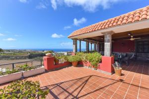 a house with a patio with a view of the ocean at Traditional Arucas by VillaGranCanaria in Arucas