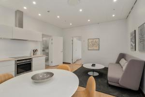 a kitchen and living room with a white table and chairs at Danhostel Copenhagen City & Apartments in Copenhagen
