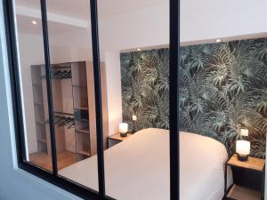 Postel nebo postele na pokoji v ubytování KALEE APPARTEMENT T2
