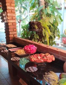 a buffet with plates of food on a table at Pousada Água de Côco in Prado