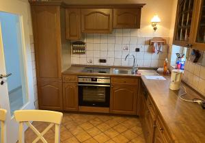 a kitchen with wooden cabinets and a sink at Hannis-Hof in Meinerzhagen