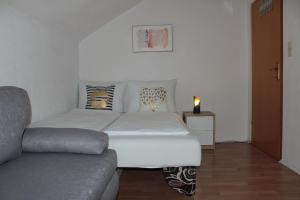 a white bed in a room with a couch at Kroatien Villa Merćepi in Katuni +38 photos