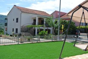 a house with a lawn in front of it at Apartments Priko in Stari Grad