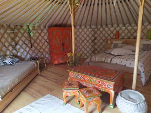 - une chambre avec 2 lits et une table dans une yourte dans l'établissement Yourte Bourgogne, à Corvol-dʼEmbernard 22 autres photos