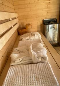 a row of three beds in a room at Wellness hiška Robida in Ljutomer